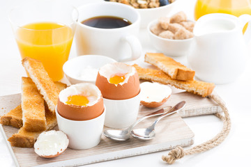 delicious breakfast with soft boiled eggs and crispy toasts