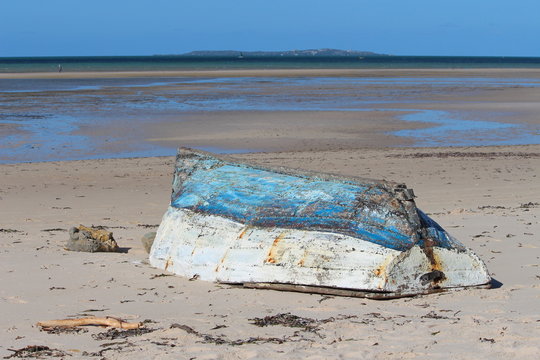 Old blue and white fishing boat at the beach of Vilankulo