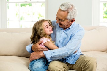 Smiling granddad hugging girl 