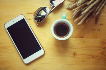 Smart phone with coffee cup and sunglass
