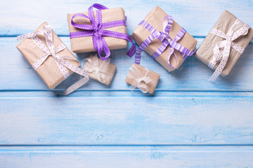 Many  festive gift boxes with presents on blue wooden background