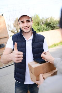 young delivery parcel service man with his commercial van on background