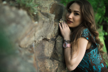 Fine art portrait of sexy woman in dress at the rocks