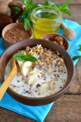 Granola with milk, walnuts and a banana for breakfast