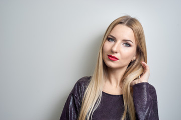Fashion model with bright makeup. Portrait of young fashion woman with long blond hair
