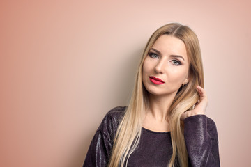 Fashion model with bright makeup. Portrait of young fashion woman with long blond hair