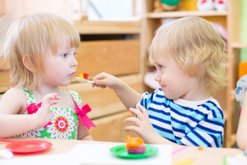 Obraz na płótnie Canvas two kids playing in kindergarten together