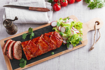 baked bacon wrapped  meatloaf with salad