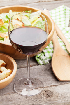 Red wine glass and caesar salad