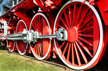 The wheels of an old steam engine