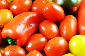 Mixed fresh colored vegetables: red peper, red and yellow tomatoes. Close up image.