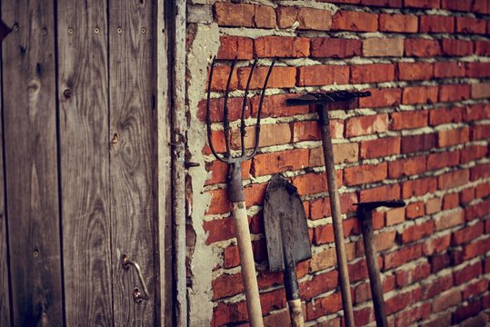 country tools on the red brick wall