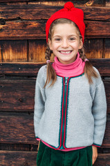 Summer holidays in the mountains a little girl in typical alpin