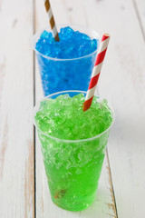 Colorful summer slushies on white wood


