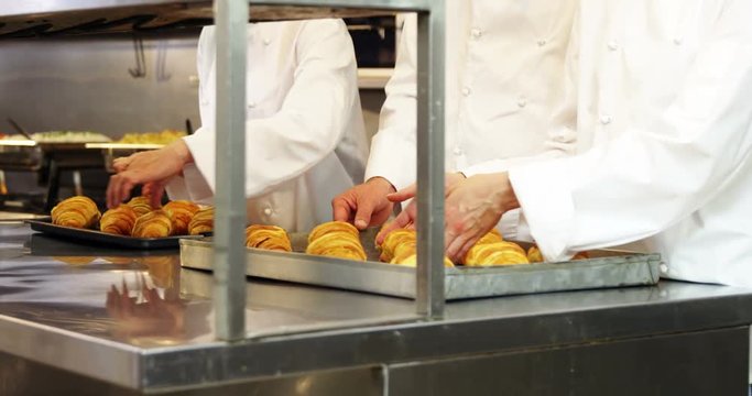 Chefs baking croissants
