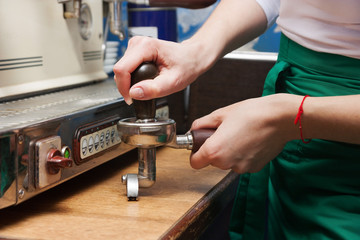 woman presses the coffee