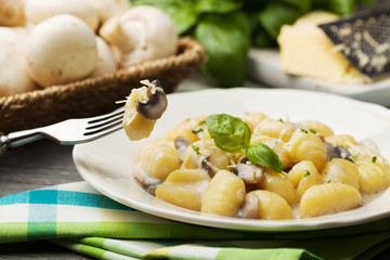 Portion of gnocchi with mushroom sauce and cheese.
