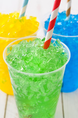 Colorful summer slushies on white wood
