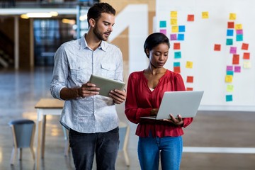 Colleagues interact using digital tablet
