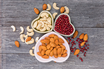Mixed beans , lentils and nuts in the white bowl on wood background