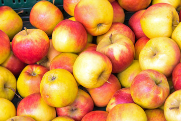 Background of red and yellow apples for sale at a market