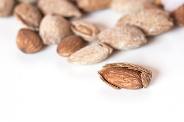 Almond on white background with a group at bottom, selective foc