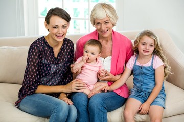 Obraz premium Smiling multi generation family with baby