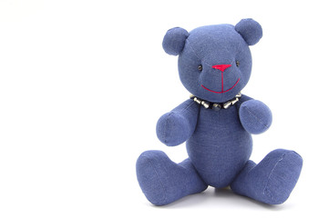Toy blue jeans bear isolated on white background