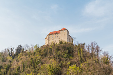 Fototapeta premium Brestanica, Slovenia - April 2, 2016. View of the Rajhenburg castle on the top of the hill.
