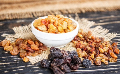 raisins in a bowl on a wooden table