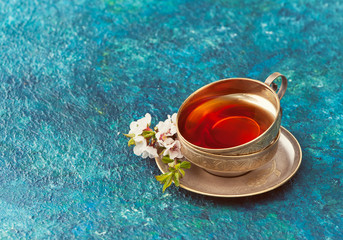 Fototapeta na wymiar Cup of tea and flowers