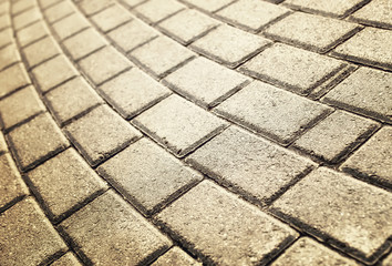 sunlight on paved cobblestone pavement