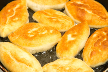Food patties in a frying pan