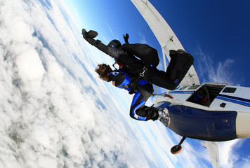 Skydiving tandem jumping from the plane - obrazy, fototapety, plakaty