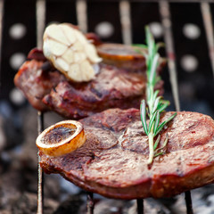 Aromatic veal steak on the grill with coals