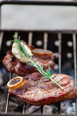 Aromatic veal steak on the grill with coals
