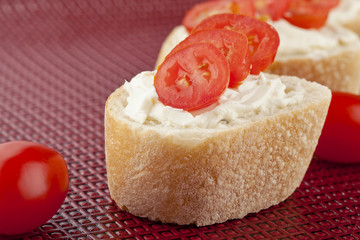 baguette bread with butter and tomato slices