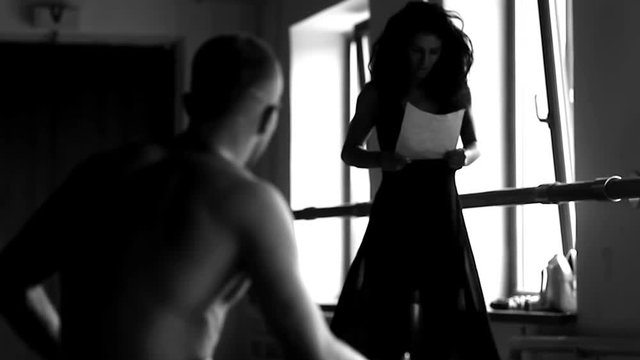 A dancing girl snatching a letter from the hands of a guy 