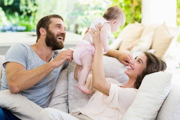 Happy parents playing with their baby