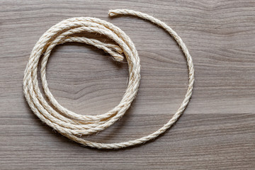 rope coiled on a wooden table