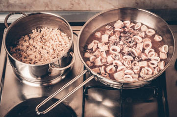 Stewed squid rings in tomato sauce in pan