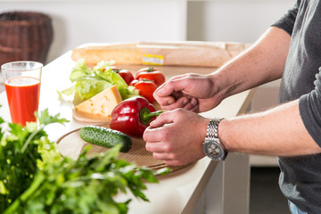 man preparing fresh salad on the kitchen