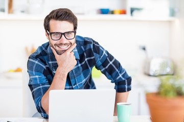 Man using laptop in the kitchen