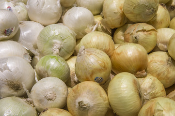 yellow onions crop from market shelves real with flaws and bruis