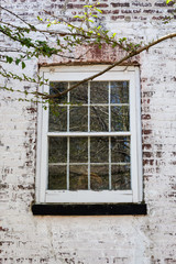 Old Window on Whitewashed Brick House