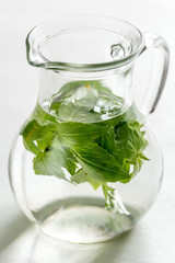 Water with fresh basil in the glass jug