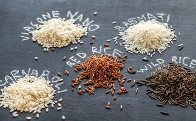 Different kinds of rice on the dark background