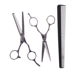 Hairdressing scissors and comb isolated on white background. Tools for cutting.