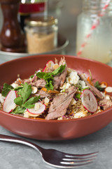 Roasted organic leg of lamb salad, served with radish, quinoa and feta cheese.
