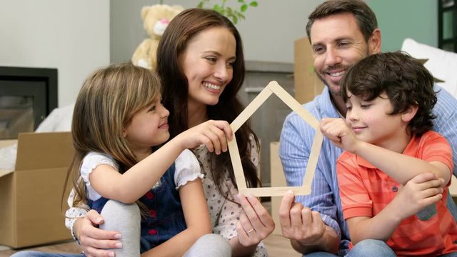A smiling family of four settling in a new place